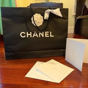 Chanel Black Shopping Bag with White Flower Accent